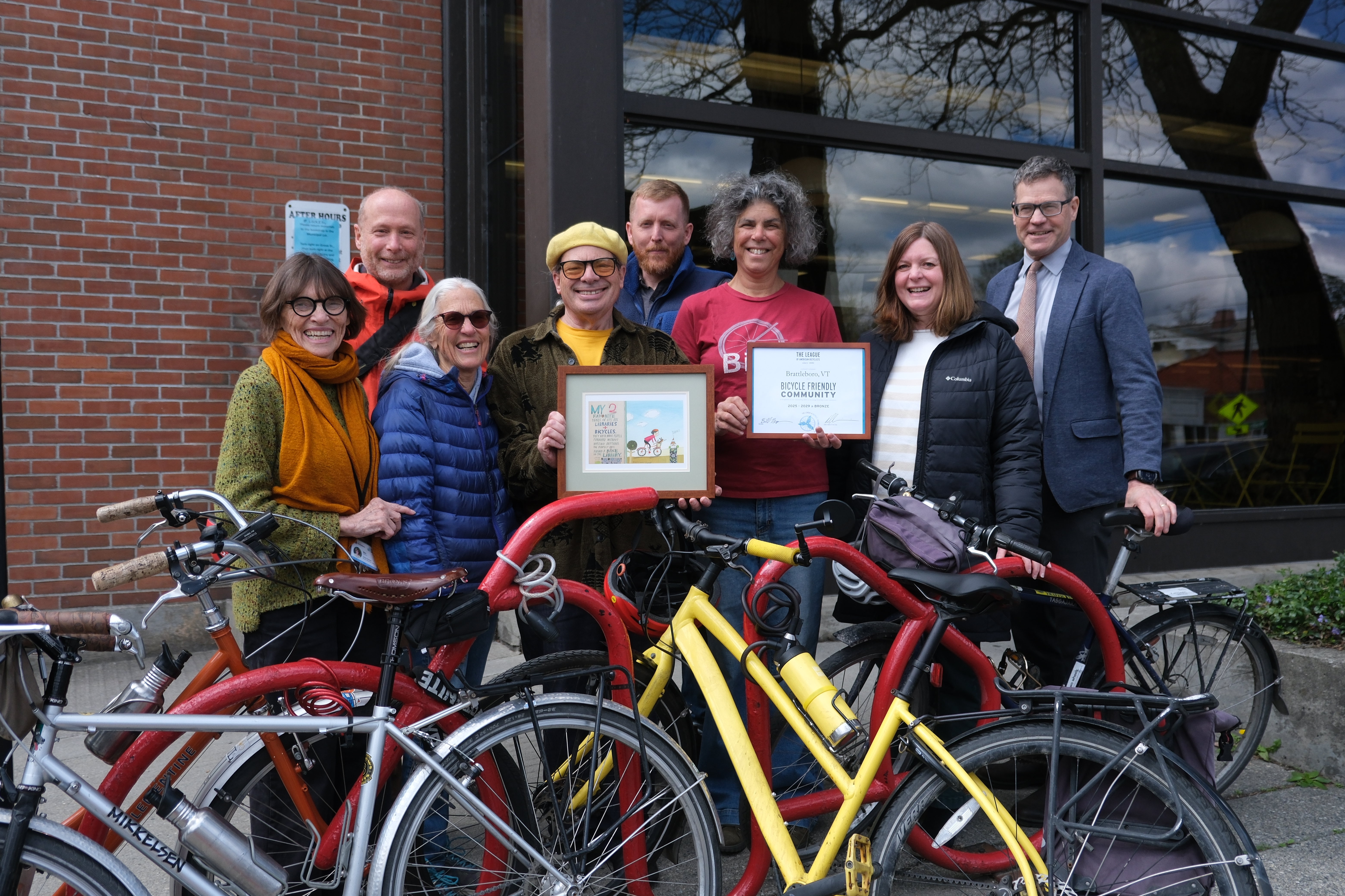 A group of Town officials and bike enthusiasts pose with the Bike-Friendly Award.