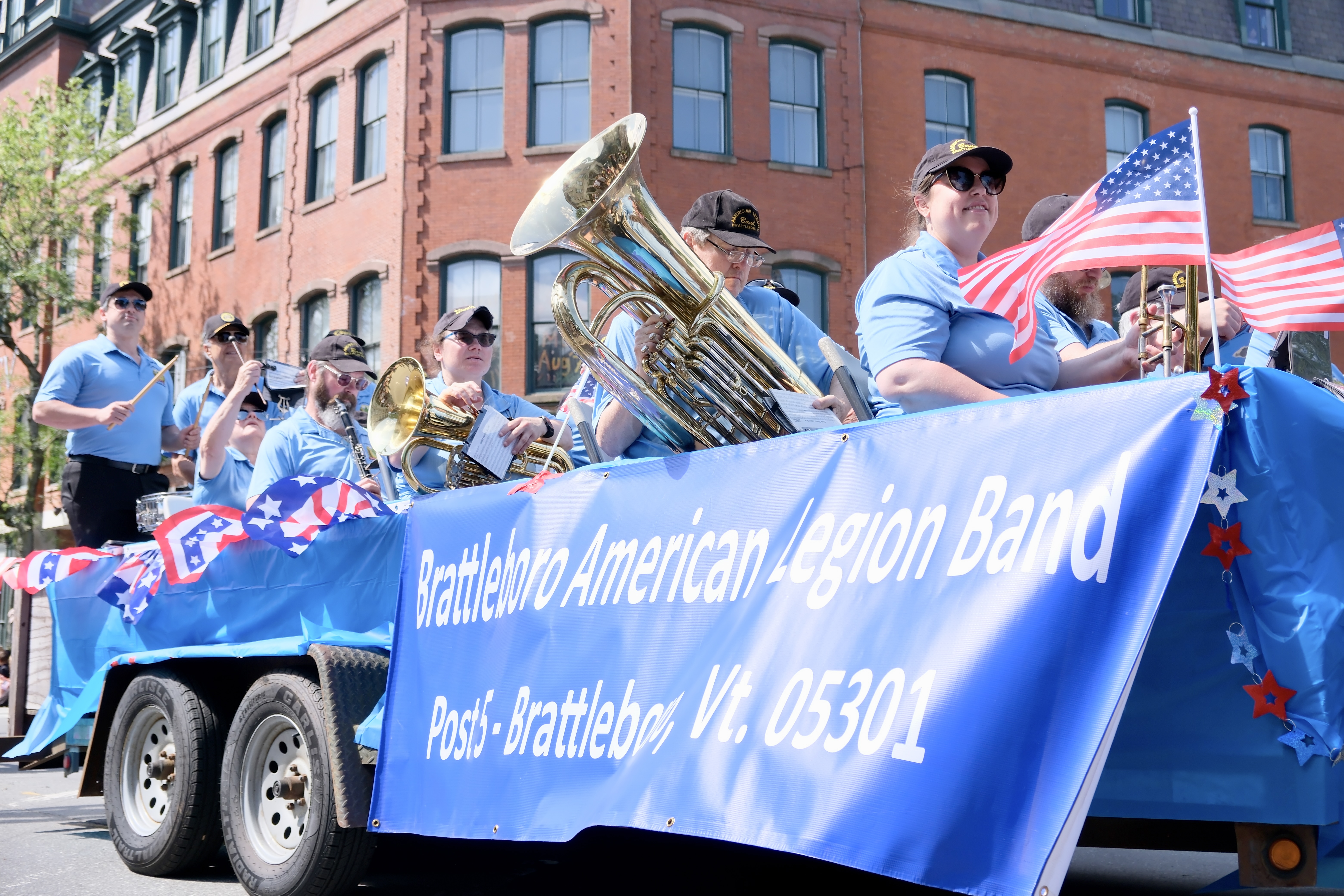 The American Legion Band performs in a mobile float during a Fourth of July parade.