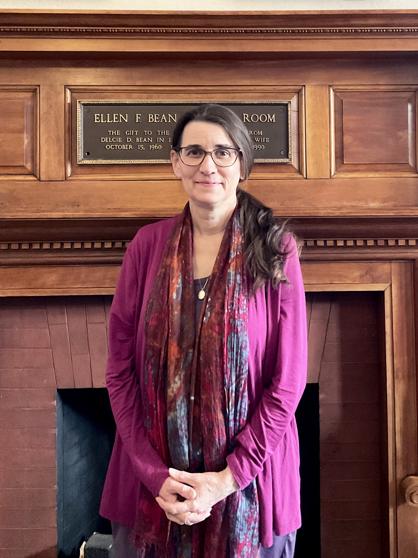 A photograph of Julie Perrin standing in the Jaffree Public Library