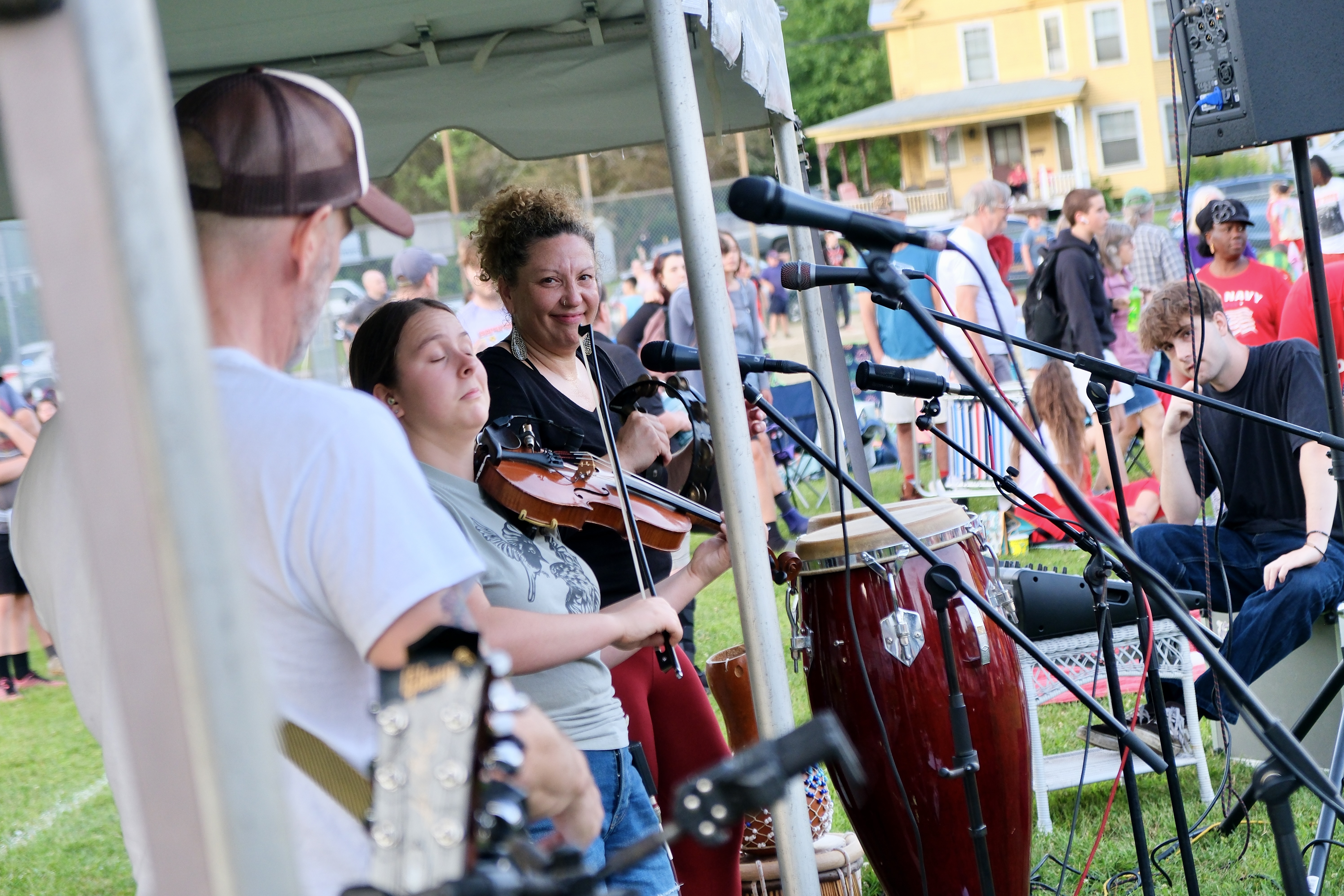 Members of a band perform during an outdoor concert.