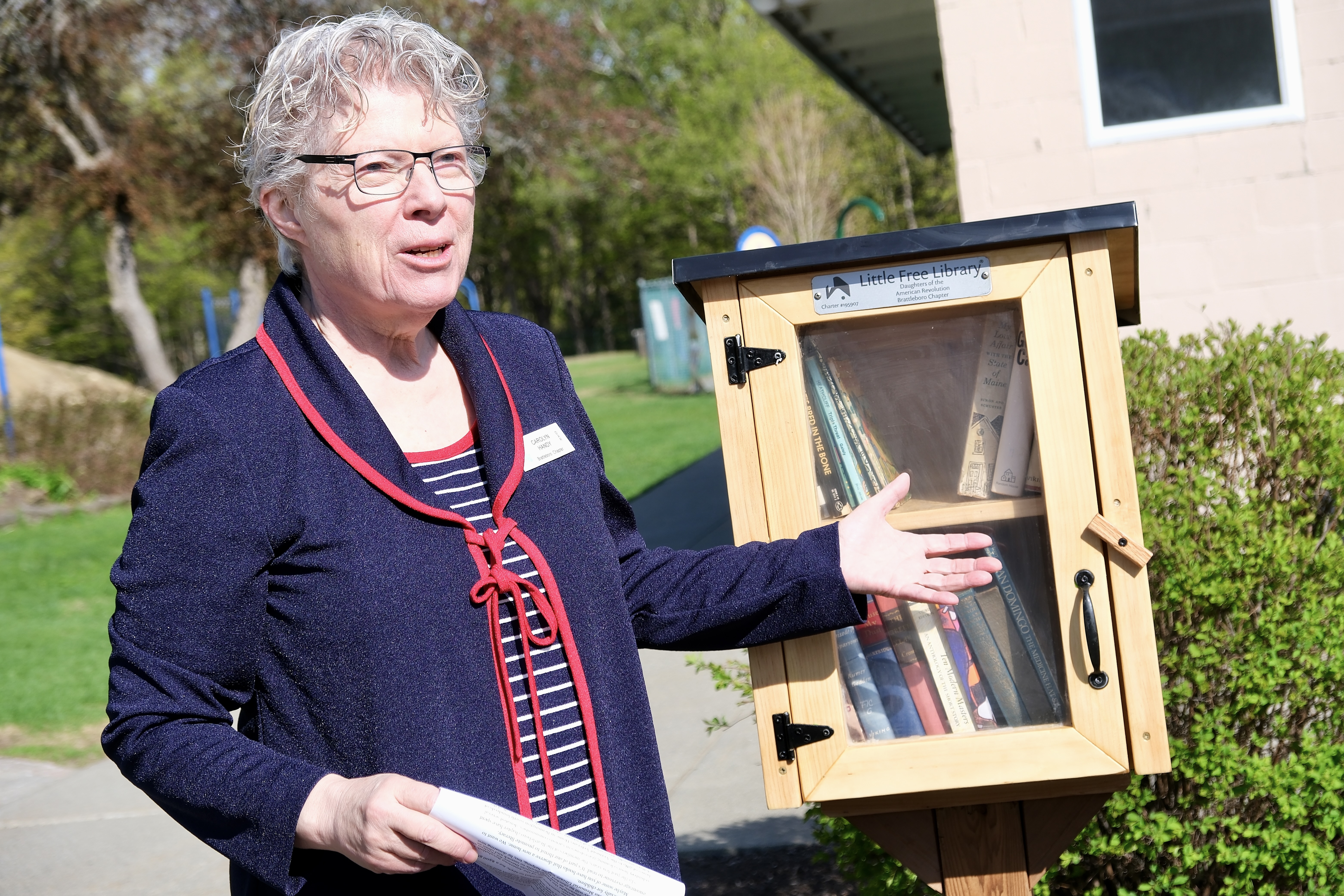 Chapter Regent Carolyn Handy gives a speech about the newly unveiled little library.